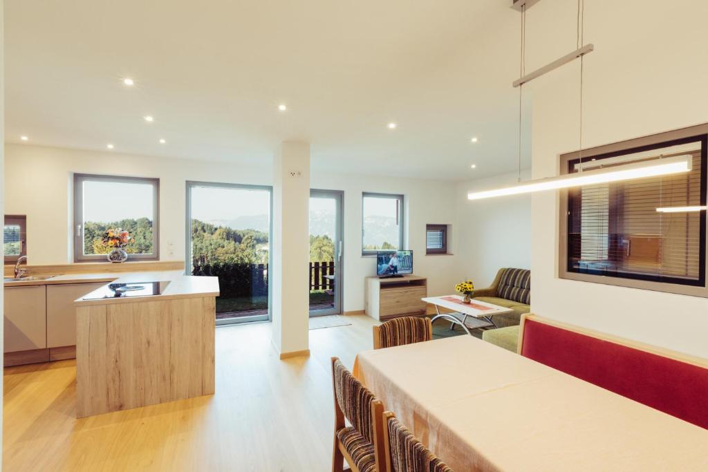 a living room with a kitchen and a dining room at Ferienwohnung Pension Stern in Aldino