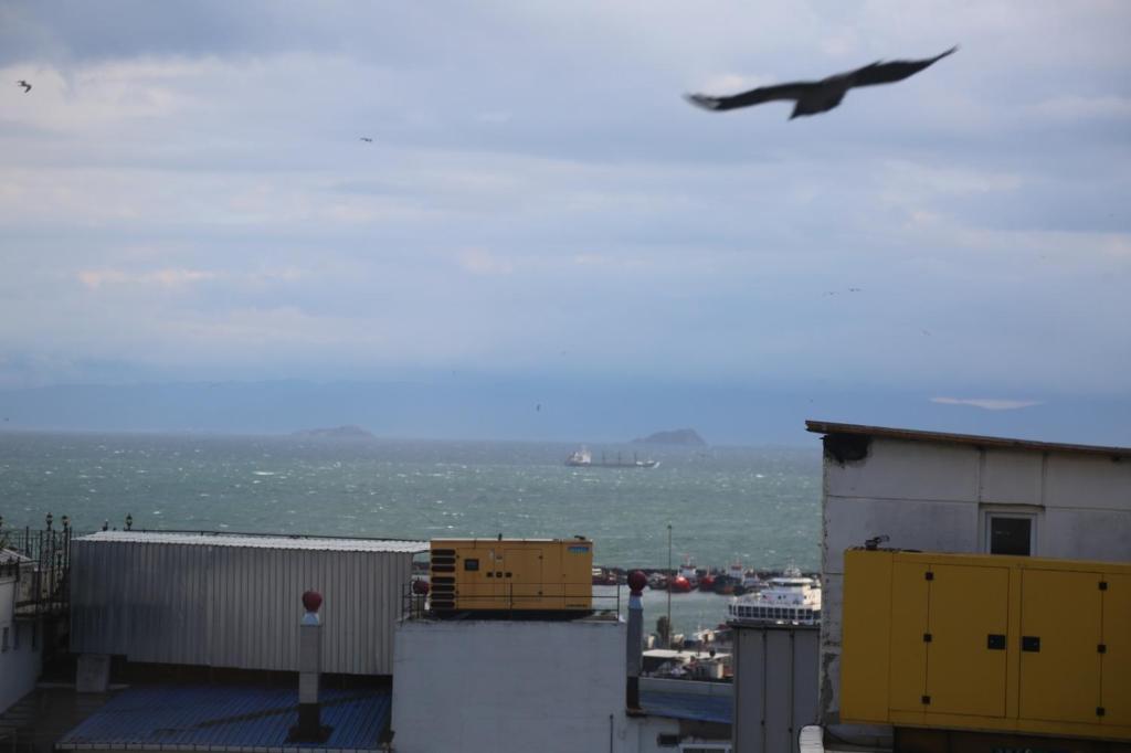 a plane flying in the sky over the ocean at EMOS HOTEL in Istanbul