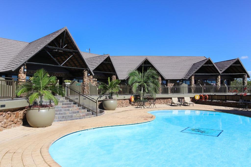 a large swimming pool in front of a resort at Zulu Nyala Game Lodge in Hluhluwe