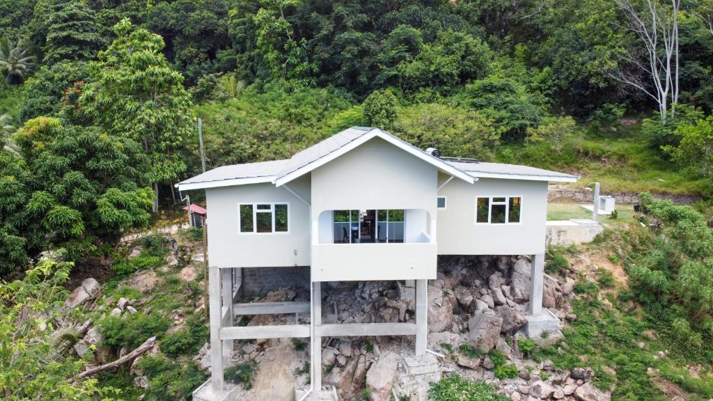 a house on the side of a hill at CAM Getaway Villa in Anse Possession