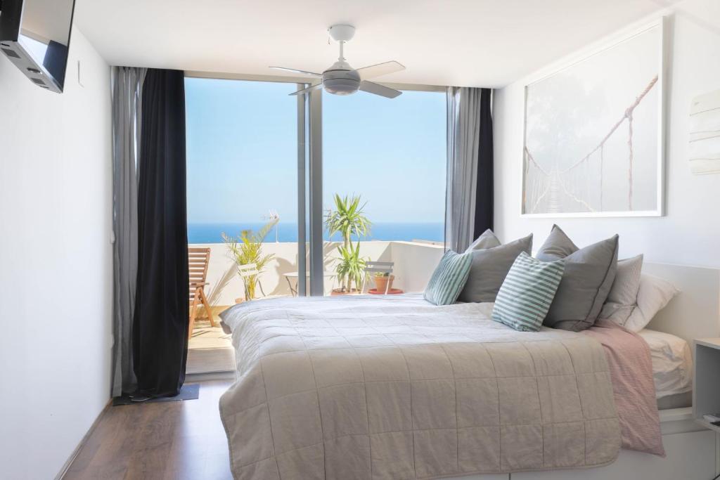 a bedroom with a bed with a view of the ocean at Stay In Carabassi II in Gran Alacant