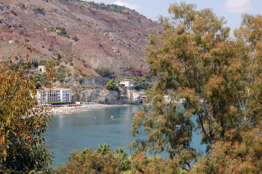 a view of a river with trees and a mountain at Hotel Lido Mediterranee in Taormina