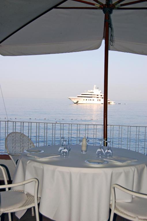 a table with a cruise ship in the ocean at Hotel Lido Mediterranee in Taormina