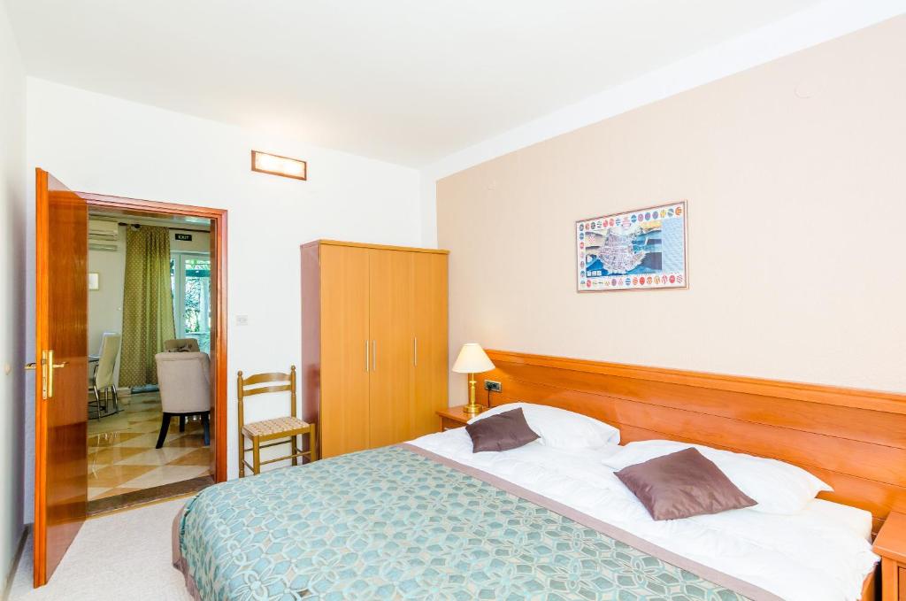 Posteľ alebo postele v izbe v ubytovaní Apartments Nicol