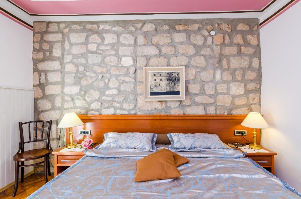 Posteľ alebo postele v izbe v ubytovaní Apartments Nicol