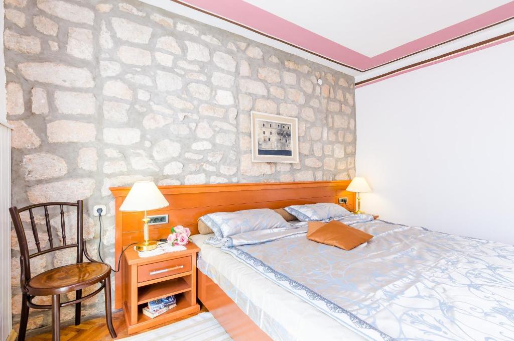 Posteľ alebo postele v izbe v ubytovaní Apartments Nicol