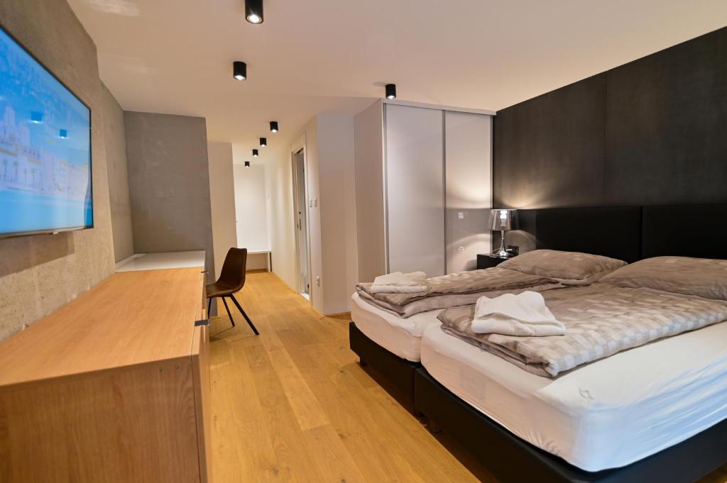 a bedroom with two beds and a flat screen tv at The Place Apartments Split in Split