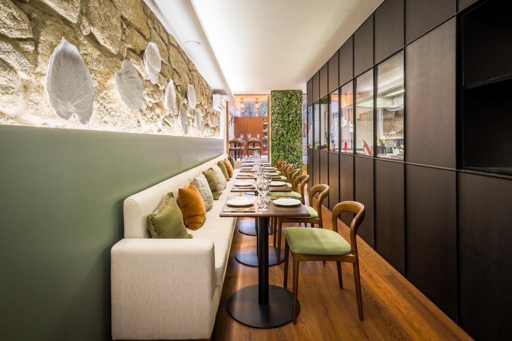 a long dining room with a long table and chairs at Gallery Hostel in Porto