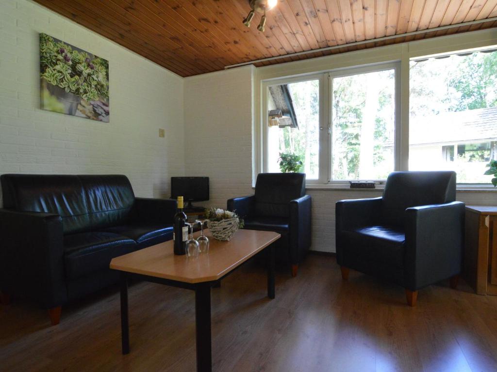 a living room with couches and a coffee table at Holiday Home in Stramproy near Nature Reserve in Stramproy