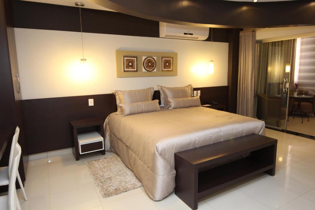 a hotel room with a bed and a lamp at Residence Hotel Imperatriz in Imperatriz
