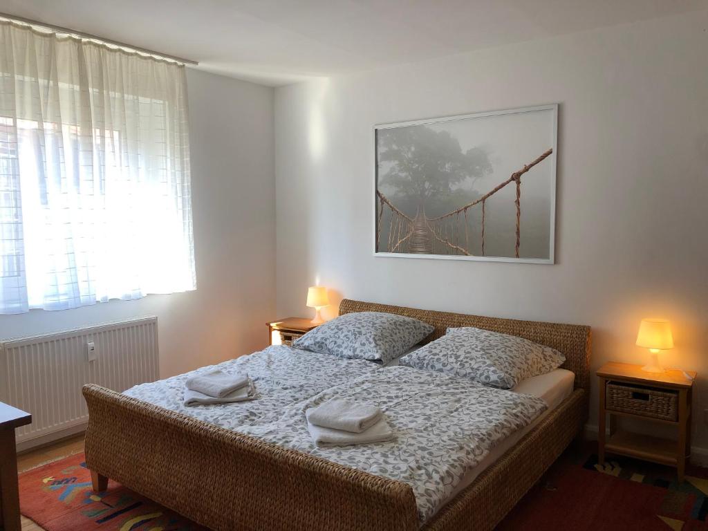 a bedroom with a bed with two towels on it at Ferienwohnung im schönen Neuenheim in Heidelberg