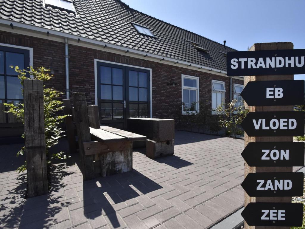 a street sign in front of a brick building at Apartment Hazenborgh near the coast in Callantsoog in Callantsoog