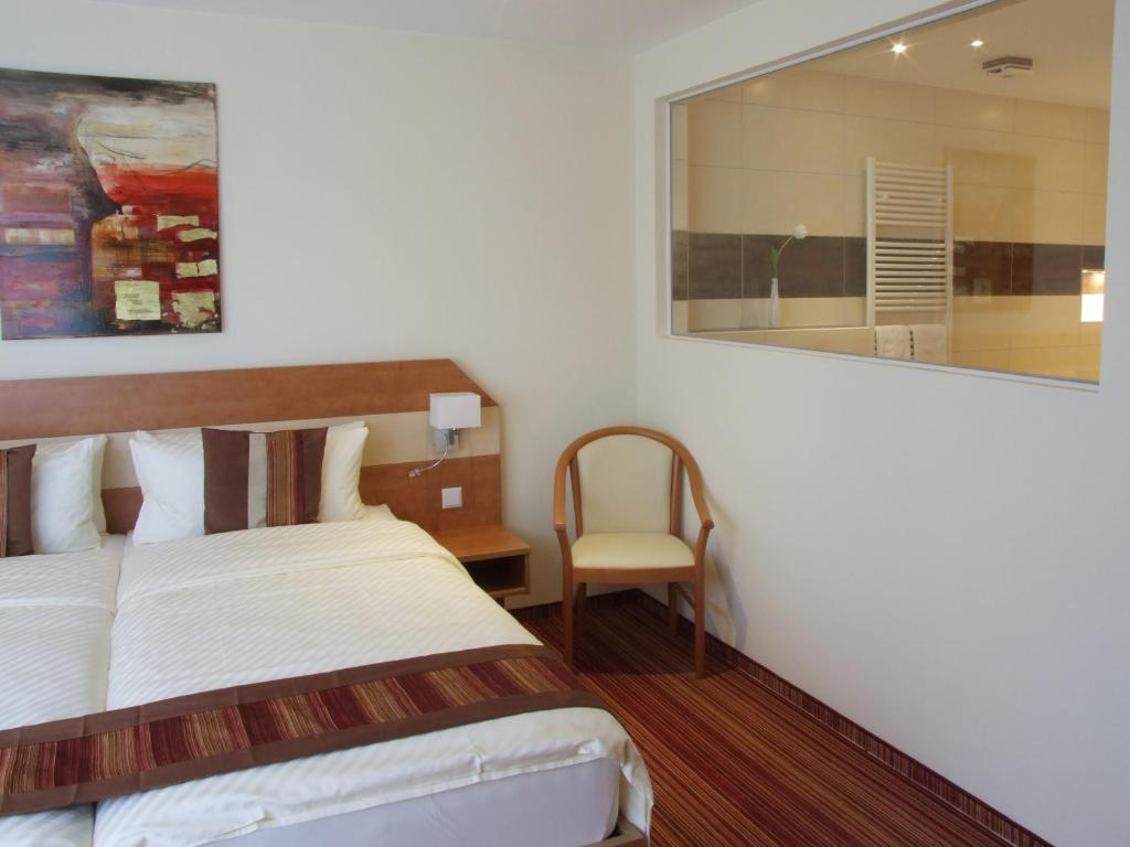 Postel nebo postele na pokoji v ubytování Boutique Hotel Wolfsburg
