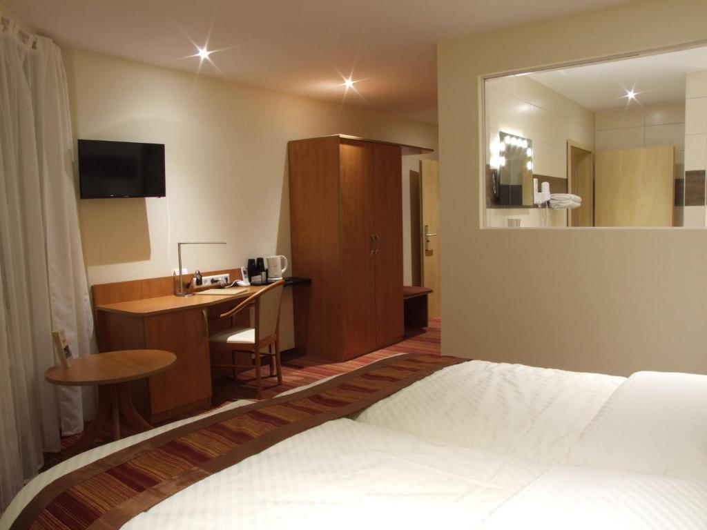 Postel nebo postele na pokoji v ubytování Boutique Hotel Wolfsburg