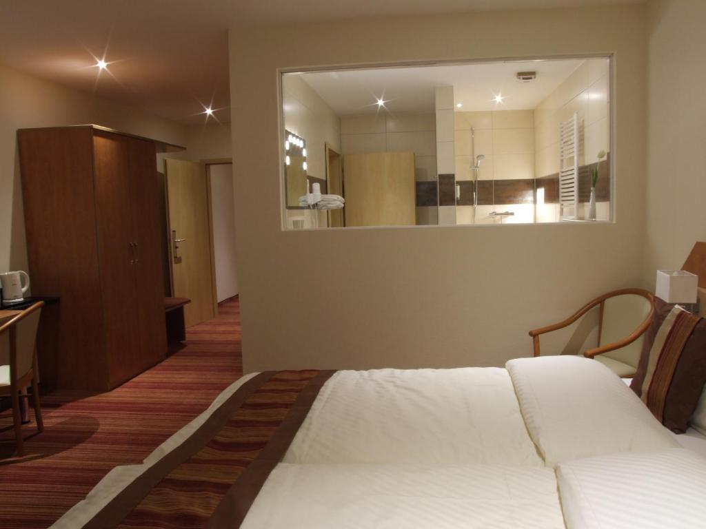 Postel nebo postele na pokoji v ubytování Boutique Hotel Wolfsburg