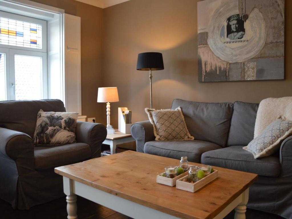 a living room with two couches and a coffee table at Cozy apartment in Roasting near the Belgian border in Roosteren