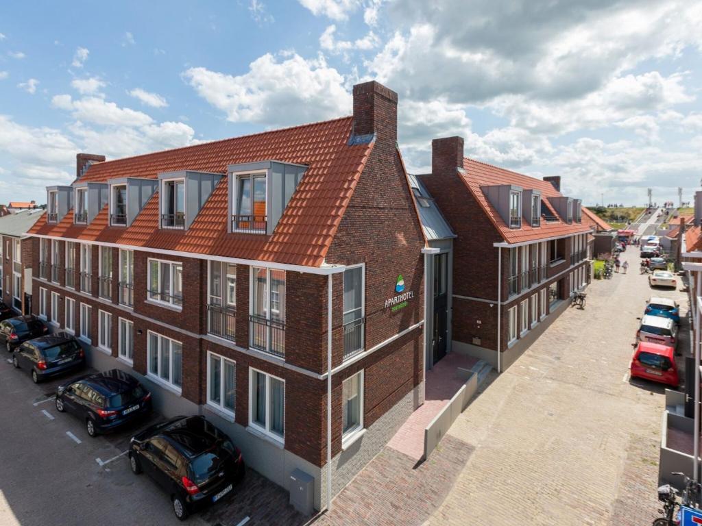 an overhead view of a building with cars parked in a parking lot at Apartment in Zoutelande near the Beach in Zoutelande