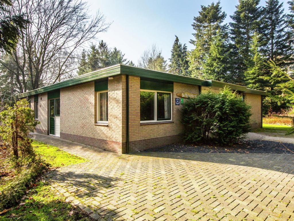 a house with a brick driveway in front of it at Cozy home with lots of privacy, in the forest in De Bult