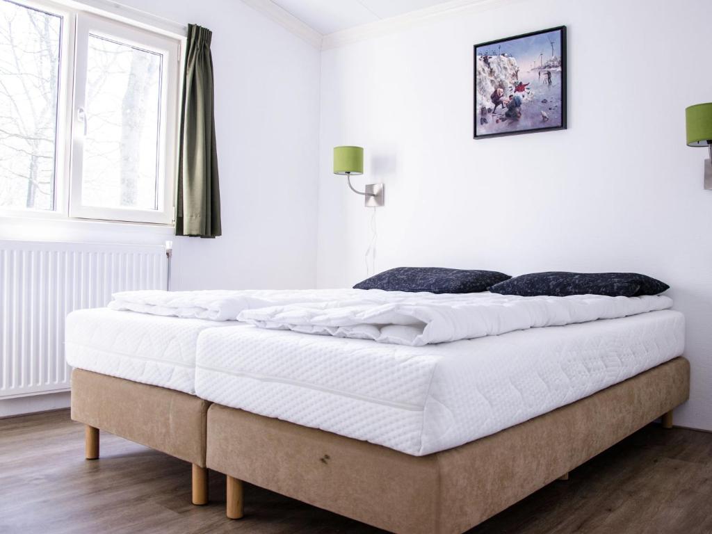 a white bedroom with a large bed in it at Unique Stay with Cozy Alcoves in De Bult