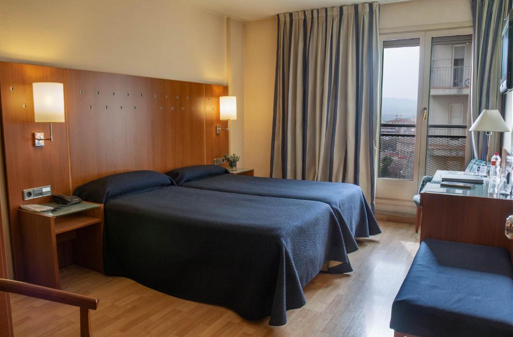 Postel nebo postele na pokoji v ubytování Hotel J. Balmes Vic