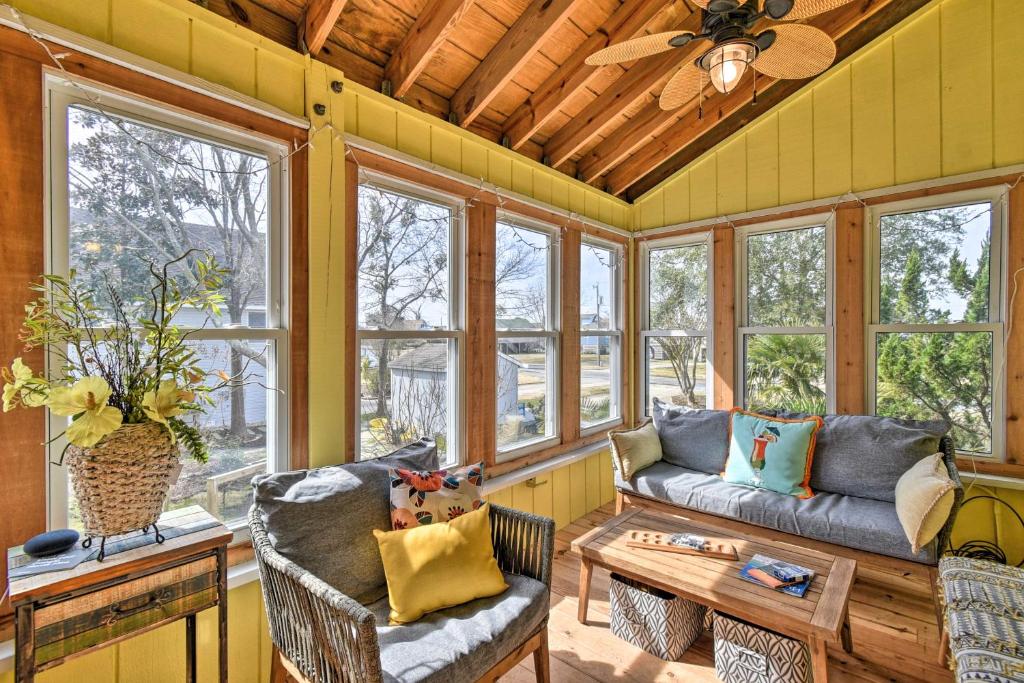 a living room with a couch and a table at High-End Canalfront Paradise with Dock and Kayaks! in Kill Devil Hills