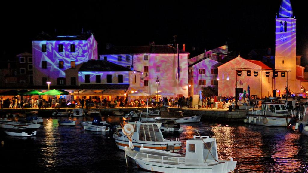 a group of boats docked in a harbor at night at Pleasing place in Fažana