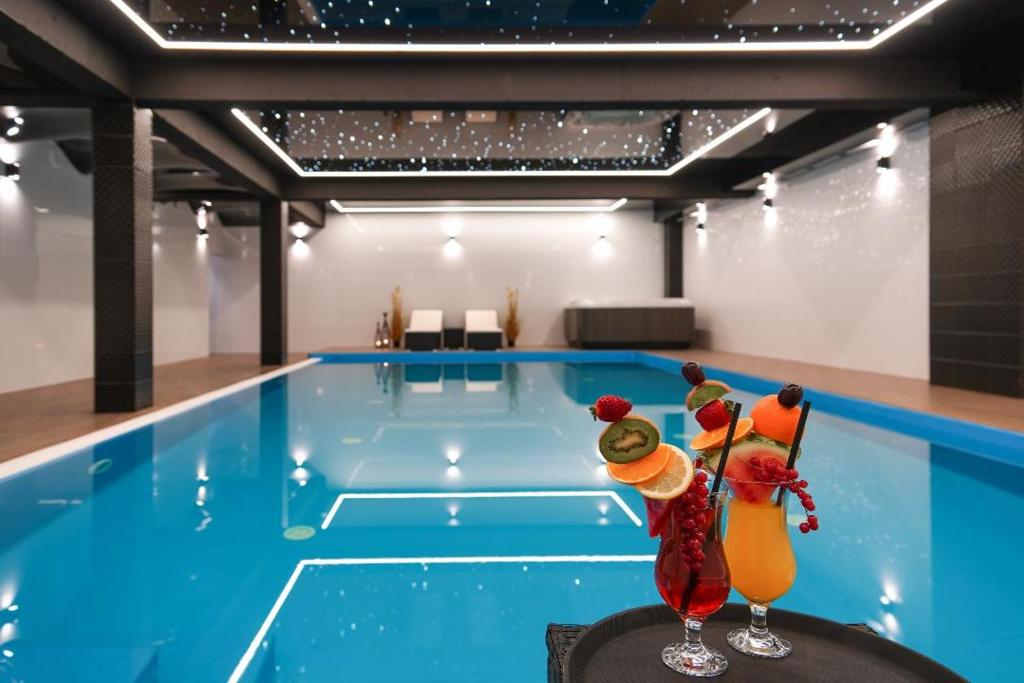 a swimming pool with two figurines in front of it at Domki Bungalow Stella Resort & SPA in Władysławowo