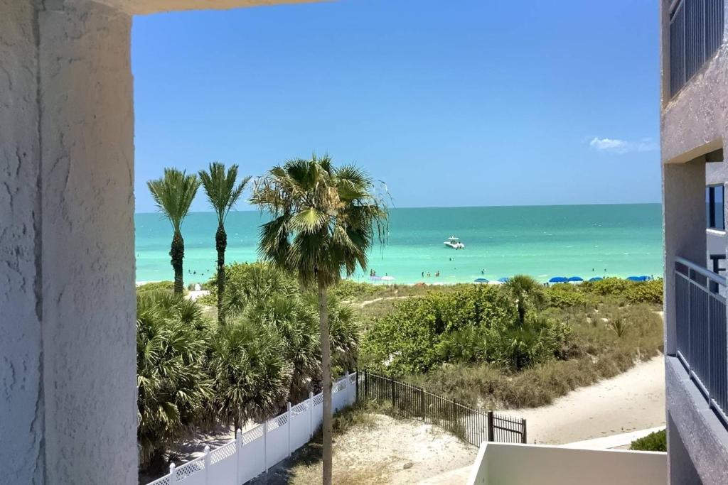 a view of the beach from the balcony of a building at Siesta Sands Beach Resort 4th Floor with Elevator in Sarasota