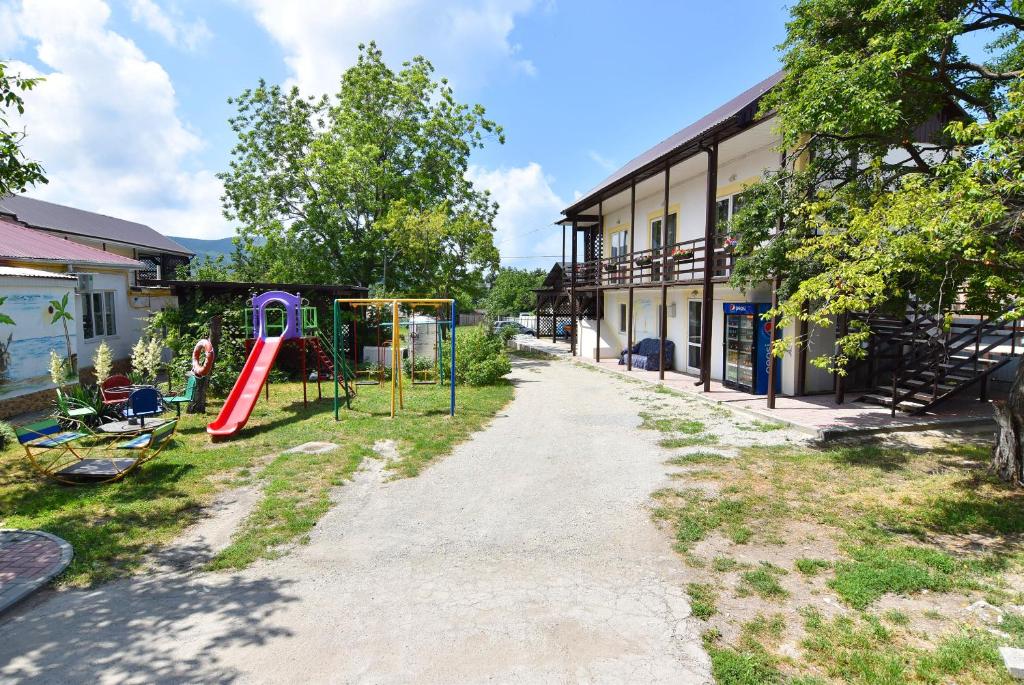 a playground in front of a building at Гостевой дом на Коллективной in Kabardinka