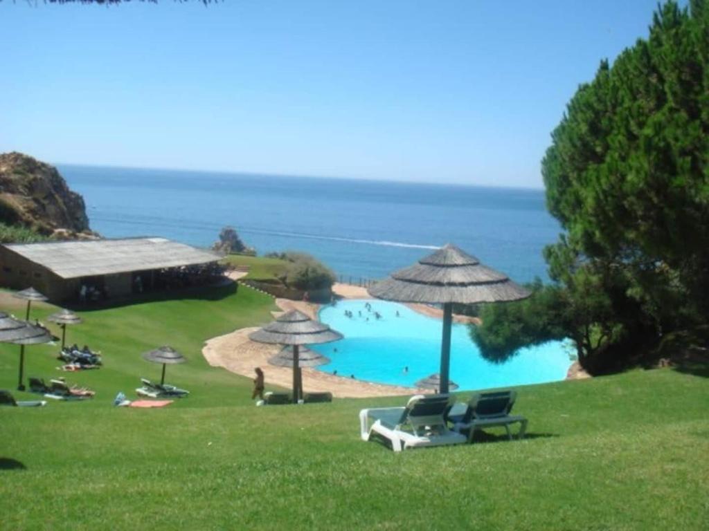 a view of a beach with chairs and umbrellas at Fantástica Casa com 4 Quartos na Praínha in Alvor