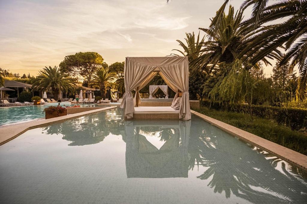 a tent is sitting in the middle of a swimming pool at Art Hotel Debono in Gouvia