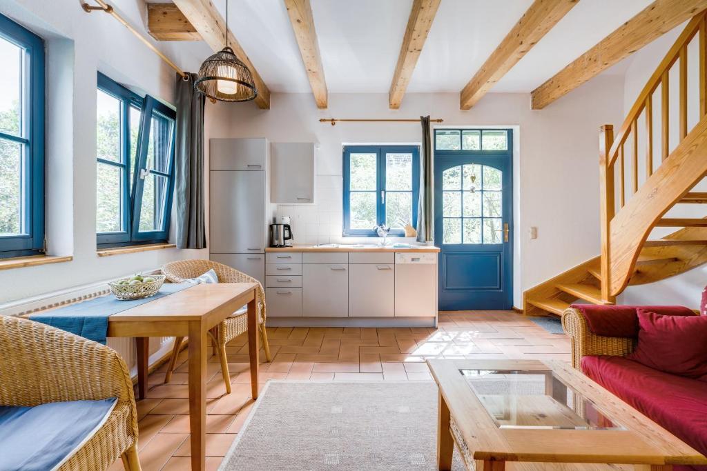 a kitchen and living room with a table and chairs at Am Achterwasser DORF 12 in Rankwitz