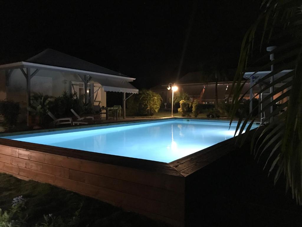 a swimming pool lit up at night at résidence Kaz'Tinou - Allo Sé Ann in Saint-François