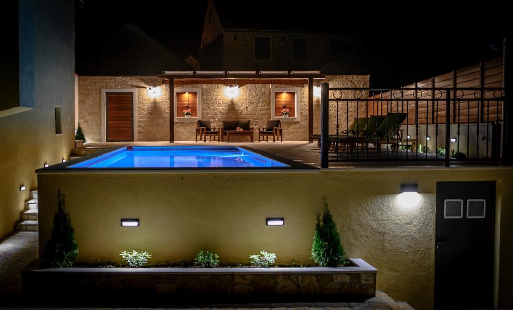 a swimming pool in a backyard at night at Villa Breeze - perfect getaway in untouched nature in Bisko