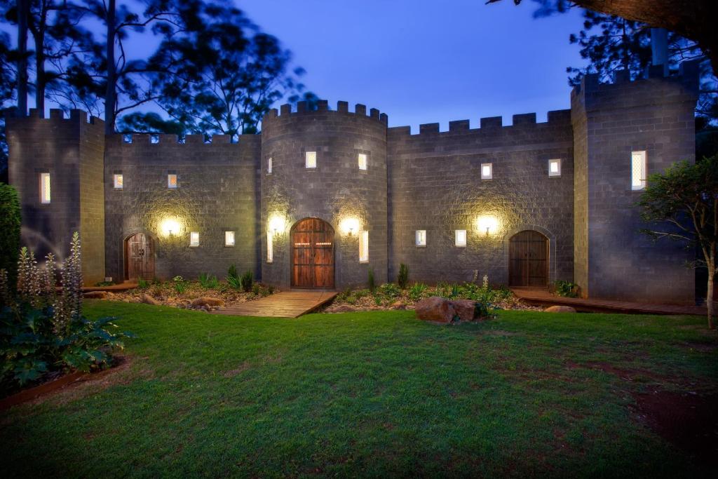 a castle at night with a lawn in front of it at The Castle on Tamborine in Mount Tamborine