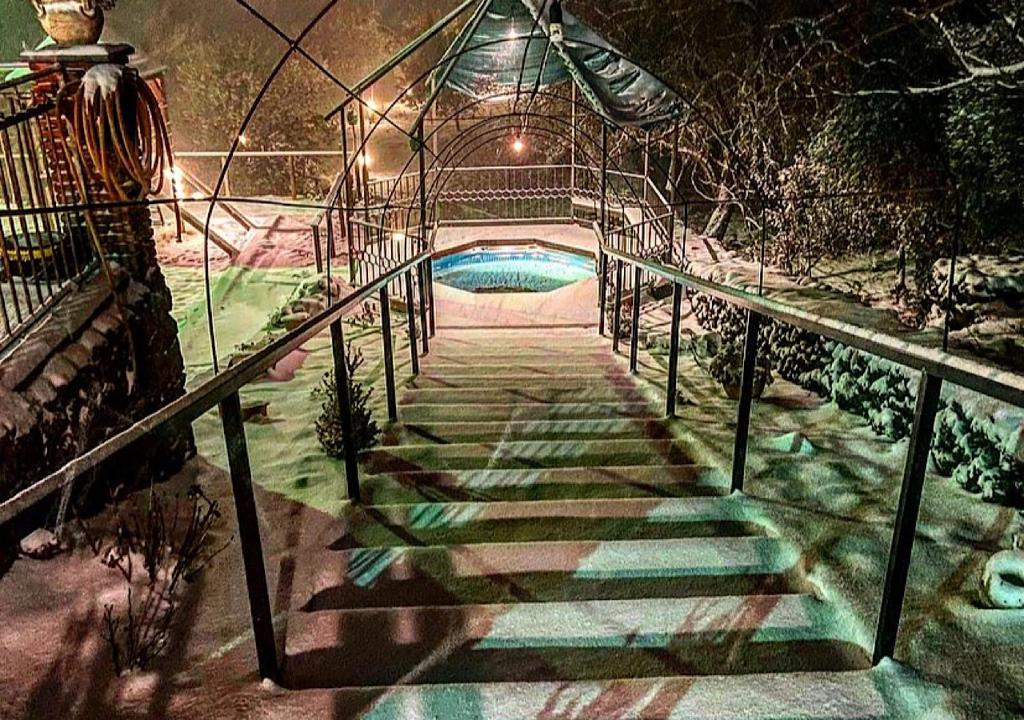 a stairway leading to a swimming pool at night at Casa Monte Etna in Maletto