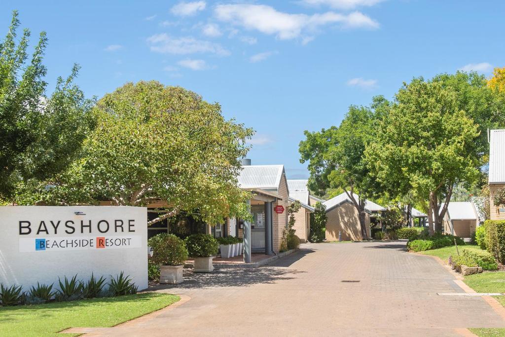 a house with a bayshore sign in a driveway at Bayshore Beachside Resort in Dunsborough