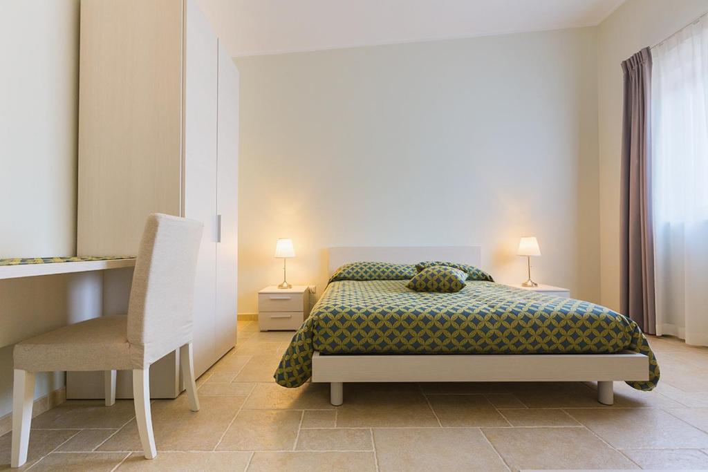 Łóżko lub łóżka w pokoju w obiekcie Residence Masseria Santa Lucia