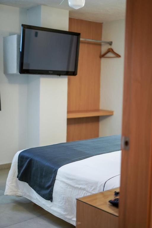 Postel nebo postele na pokoji v ubytování Hotel Emperador centro Guadalajara y Remodelado