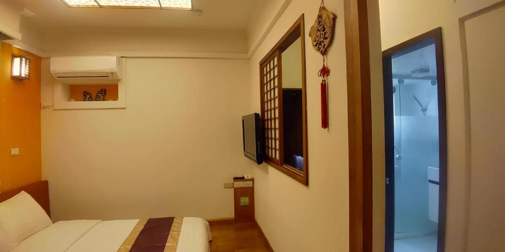 Postel nebo postele na pokoji v ubytování Purple Shell Homestay