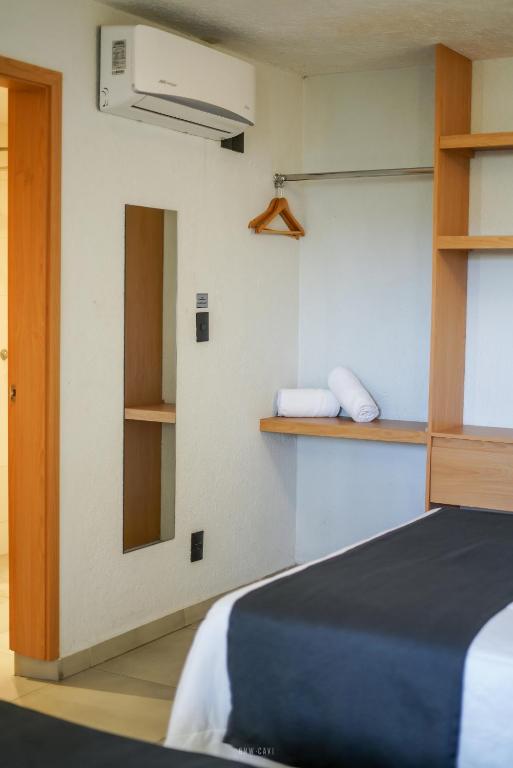 Postel nebo postele na pokoji v ubytování Hotel Emperador centro Guadalajara y Remodelado