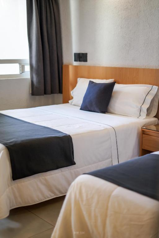 Postel nebo postele na pokoji v ubytování Hotel Emperador centro Guadalajara y Remodelado