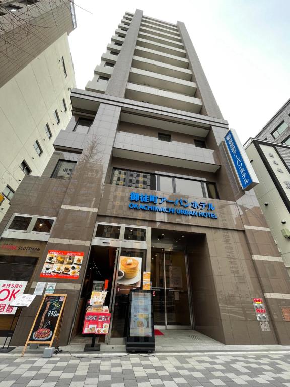 a tall building with a sign in front of it at Okachimachi Urban Hotel in Tokyo