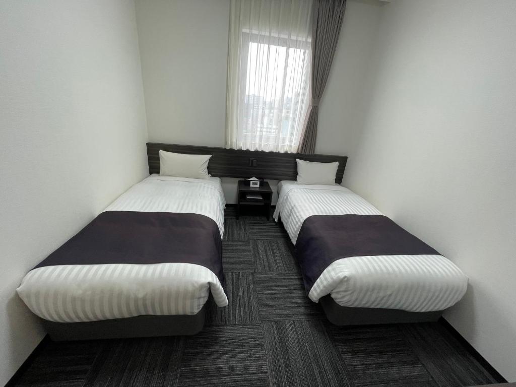 Postel nebo postele na pokoji v ubytování Okachimachi Urban Hotel