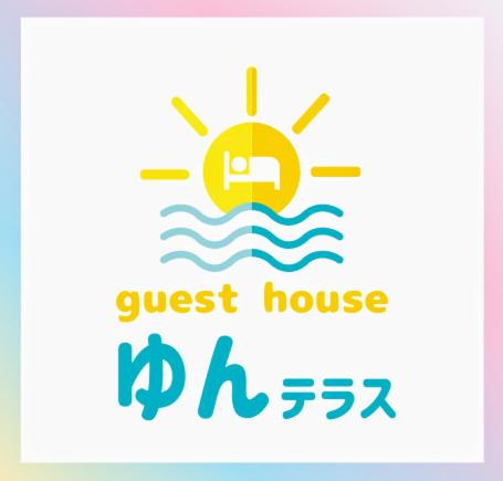 a crest house logo with a sun in the water at Guest House Yun Terrace in Ishigaki Island