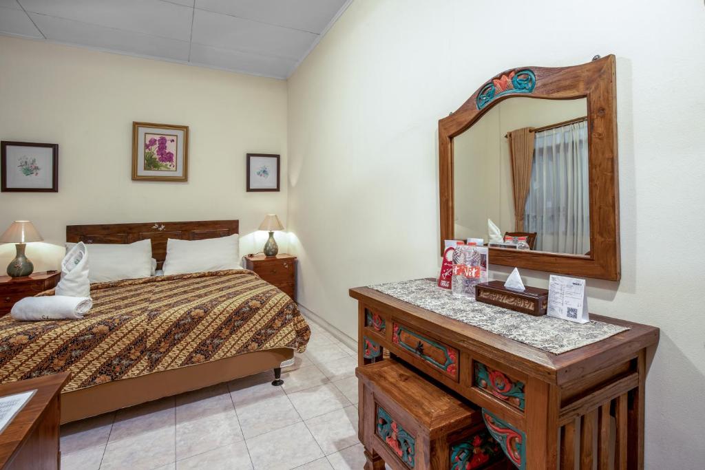 Postel nebo postele na pokoji v ubytování Sekararum Butik Syariah Guesthouse