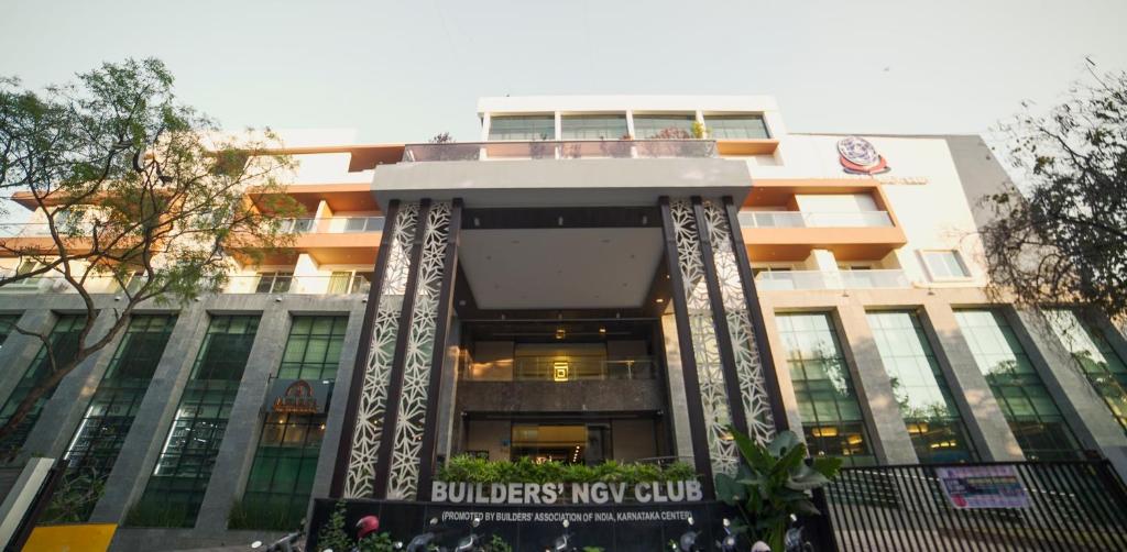 a building with a sign in front of it at BNGV Mystic Premier Hotel in Bangalore