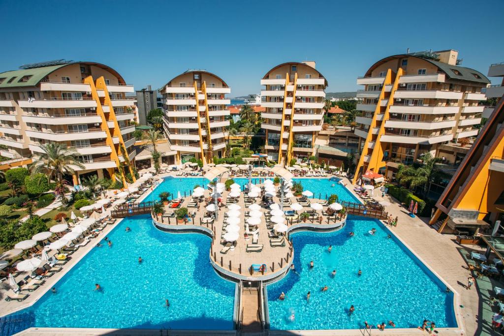 an aerial view of a resort pool with chairs and umbrellas at Alaiye Resort & Spa Hotel - Ultra All Inclusive in Avsallar