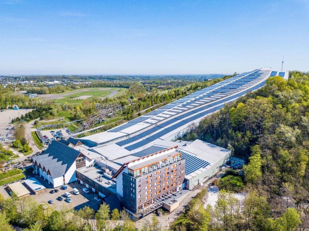 an overhead view of a building and a highway at Alpine Hotel by SnowWorld in Landgraaf