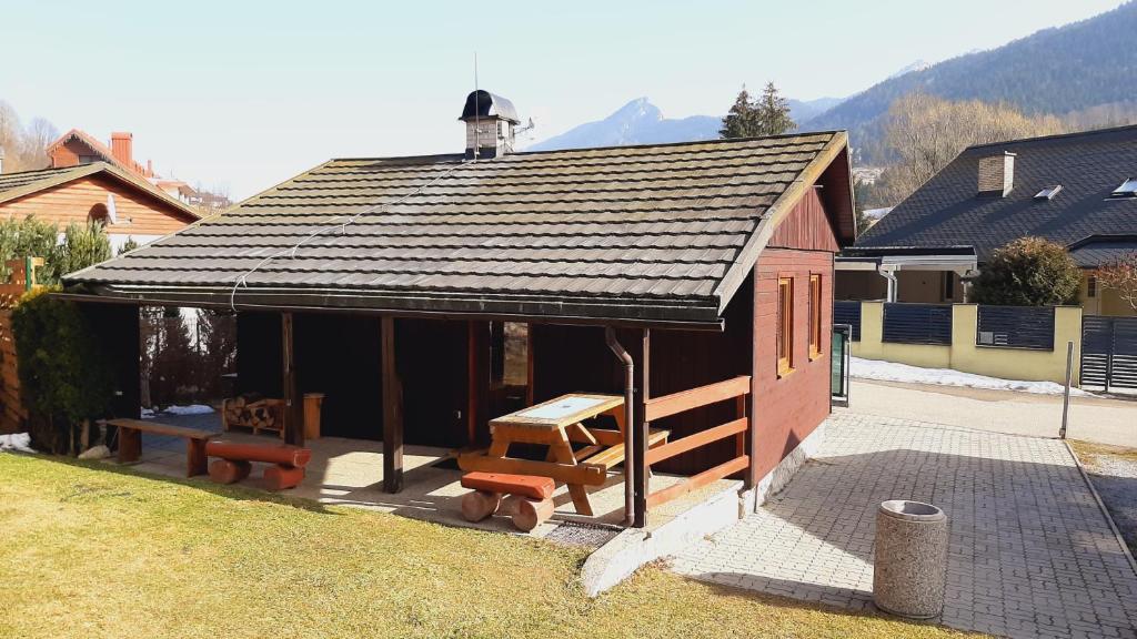 a small house with a picnic table and benches at Chata KRISTÍNA - bez kontaktu s ubytovateľom "Click 'n Sleep" in Terchová